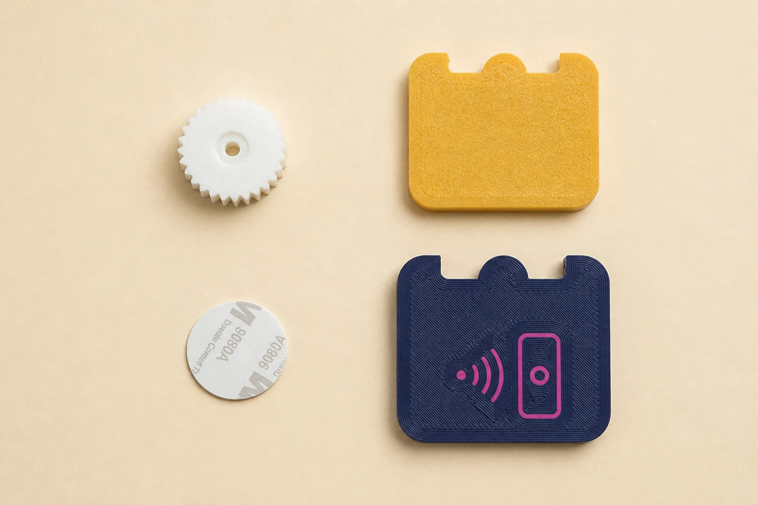 The tested fidget laid out as four parts: white wheel, yellow back shell, round NFC tag, and navy front shell
